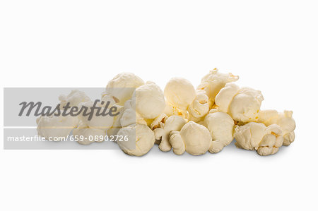 A pile of popcorn on a white surface