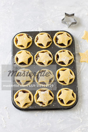 Unbaked Christmas mince pies in a muffin tin