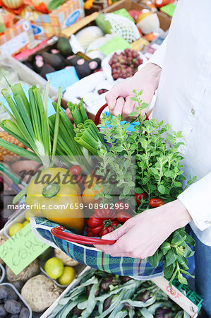 Fresh market vegetables in a checked shopping bag