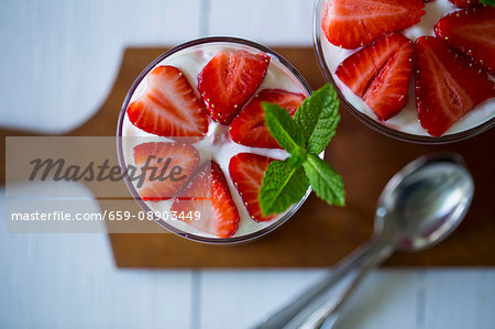 Layered strawberry deserts in glasses