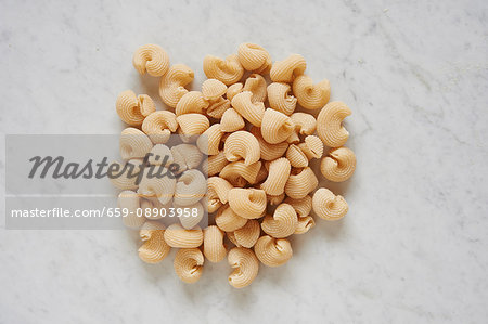 Fresh pasta on a white surface (seen from above)