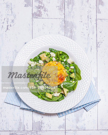 Baked eggs on pea and mint salad with feta cheese (England)