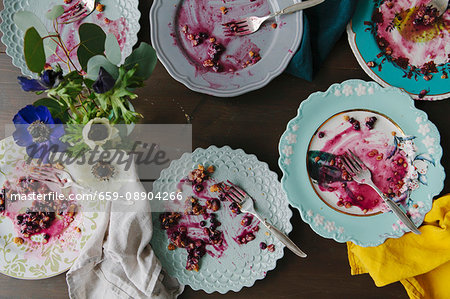 Left over blueberry pie on various plates