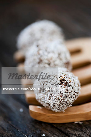 Coconut truffles on a wooden fork