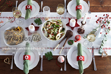 Various dishes on a table laid for Christmas dinner