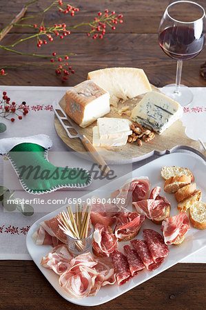 Cheese and ham platter on a Christmas dinner table Cheese and ham platter on a Christmas dinner table