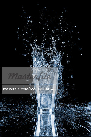 A water glass with a splash