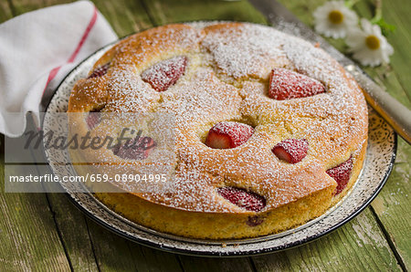 A light strawberry cake dusted with icing sugar