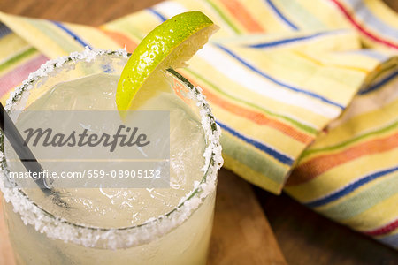 Margarita in a glass with a slice of lime and a salt-coated rim Margarita in a glass with a slice of lime and a salt-coated rim