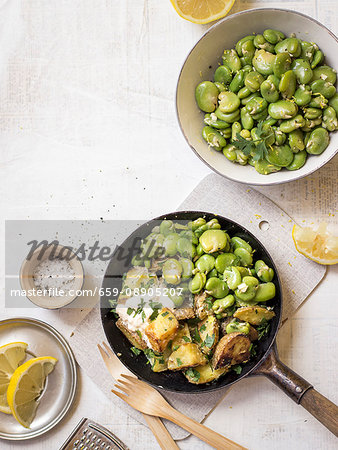 Lemon broad beans served with fried potatoes, harissa and parsley