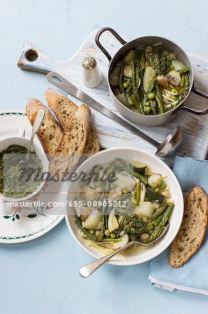 Soup with green beans, asparagus, peas, courgette, potatoes and basil pesto