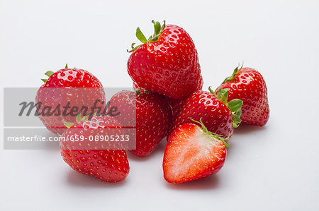 Several strawberries against a white background