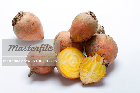 Golden beets on a white surface