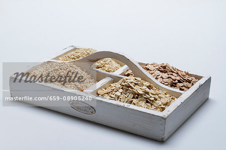 Fours types of grains on a tray with compartments