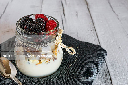 Muesli with fresh berries in a screw-top jar