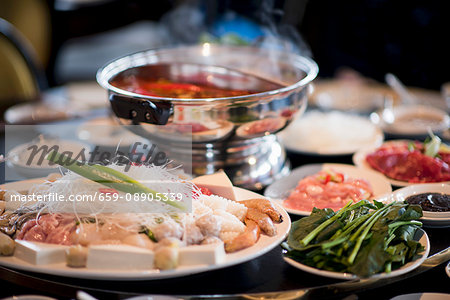 A table full of ingredients for a Chinese fondue (Asia)