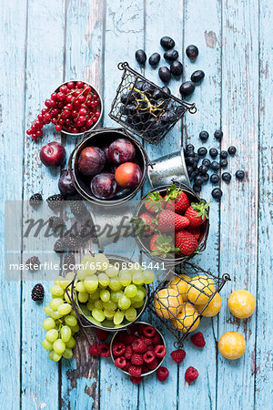 An arrangement of different types of fruit in metal containers