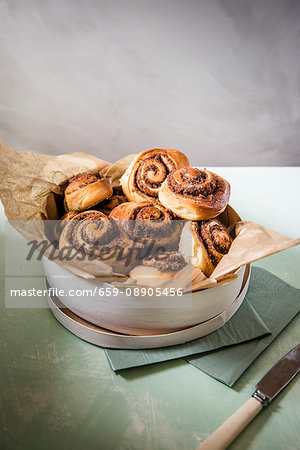 Cinnamon swirls with a pecan nut filling in a wooden box