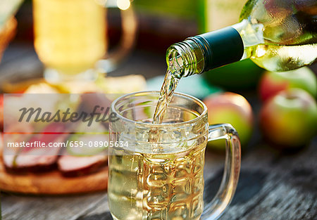 Cider being poured into a glass