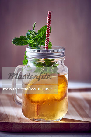 Fruit juice with mint, a slice of orange and ice cubes