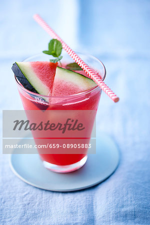 A watermelon drink in a glass with a straw