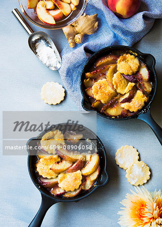 Peach cobbler in small skillets with ginger & cardamon shortbread biscuits