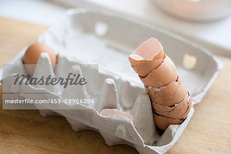 A stack of eggshells in an egg carton