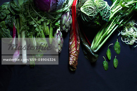 Assorted vegetables on a black surface