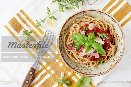 Plate of spaghettis with tomato sauce and basil