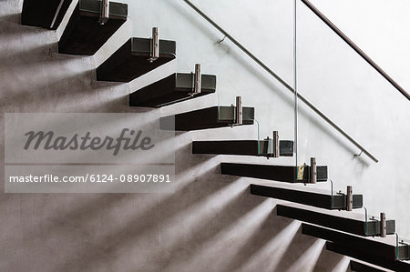 Modern, minimalist floating staircase in home showcase interior