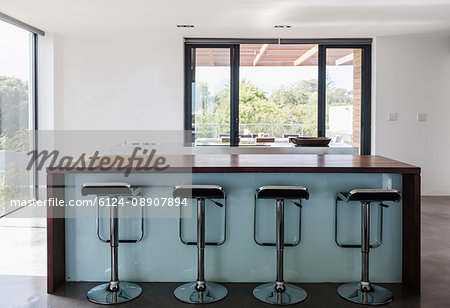 Simple, modern home showcase interior kitchen island with barstools