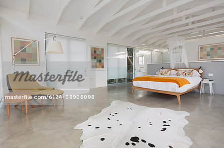 Modern, minimalist home showcase interior hotel bedroom with wood beam vaulted ceilings and soaking tub