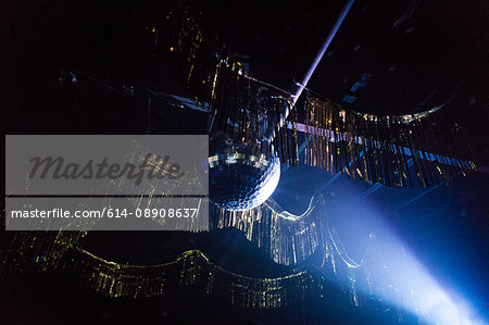 Disco ball hanging from ceiling of nightclub