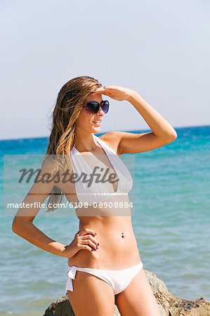 Portrait of a beautiful blonde in bikini in the beach