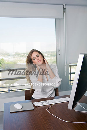 Woman with neck pain at office