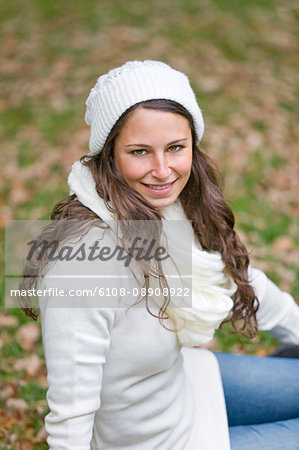 Portrait of a content woman in the park smiling at camera