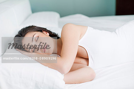 Portrait of a pretty woman sleeping in bed