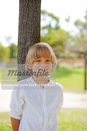 Cute blonde boy in park