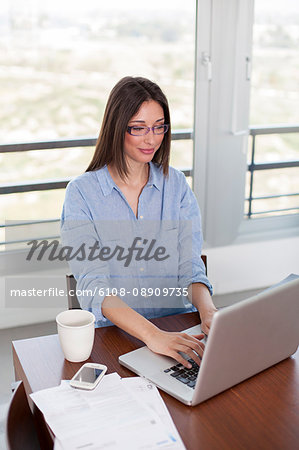 Pretty brunette woman with laptop