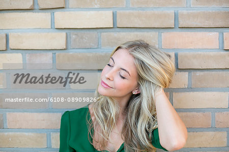 Portrait of a pretty blonde woman holding hair
