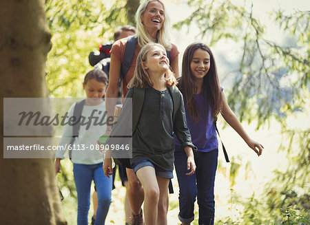 Smiling family hiking in woods