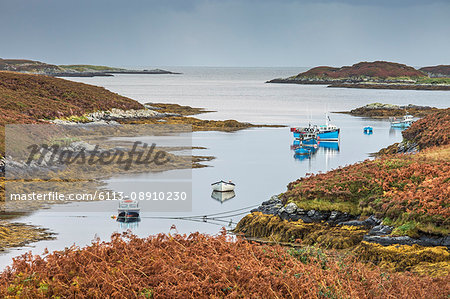 View of fishing boats on tranquil lake, Loch Euphoirt, North Uist, Outer Hebrides