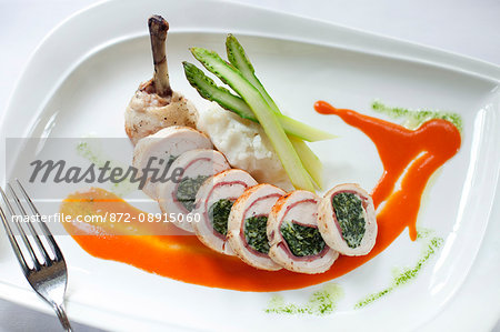 Sliced stuffed chicken served over oval plate, Club Continental, Orange Park, FL.