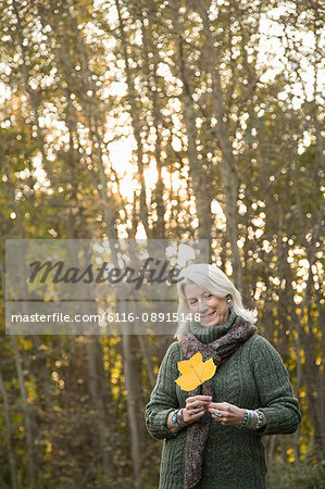 Senior woman holding a leaf