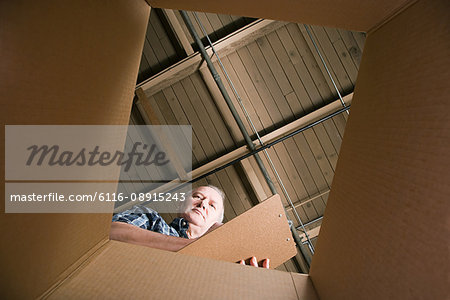 Man looking in cardboard box