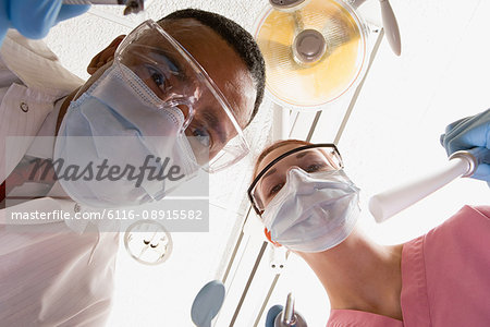 Low angle view of dentist and dental nurse