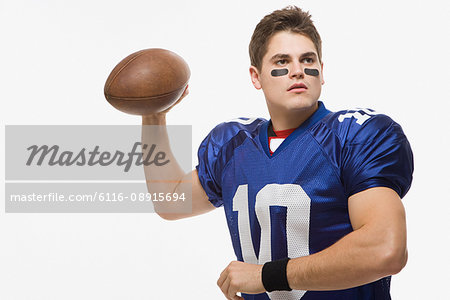 American football player throwing ball