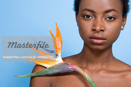 Woman holding bird of paradise flower