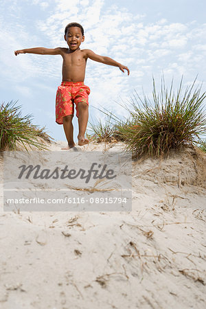 Boy walking down dune
