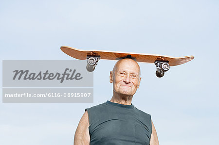 Man with skateboard on his head